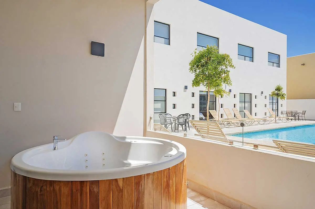 Inn at Laguna pool area with hot tub and lounge chairs