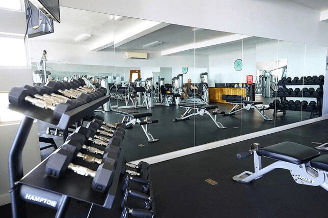 Modern fitness center with ocean views at Laguna Shores Resort